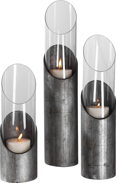 large pillar candle holders glass Uttermost Candleholders This Set Of Three Candleholders Features A Sleek Angular Design In Raw Iron And Clear Glass Cylinders With Three 3"x 3" Distressed Beige Candles Included.