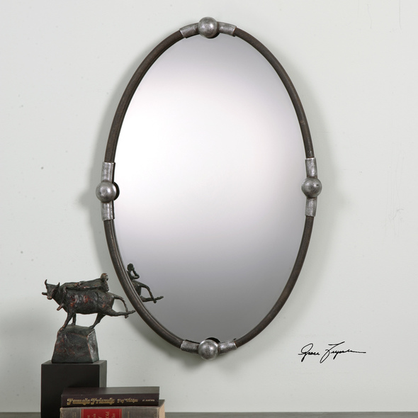 framed mirror wall Uttermost Black Oval Mirror Iron Frame Finished In A Rust Black Accented With Burnished Silver Details.