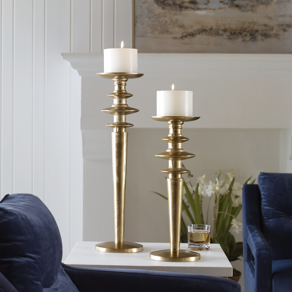 wall votive holder Uttermost Candleholders Candleholders Set Of Two Cast Aluminum Candleholders Display A Traditional Silhouette, Finished In Light Antique Gold. Includes Two 5"x 4" White Candles. Sizes: S-7x20x7, L-7x26x7
