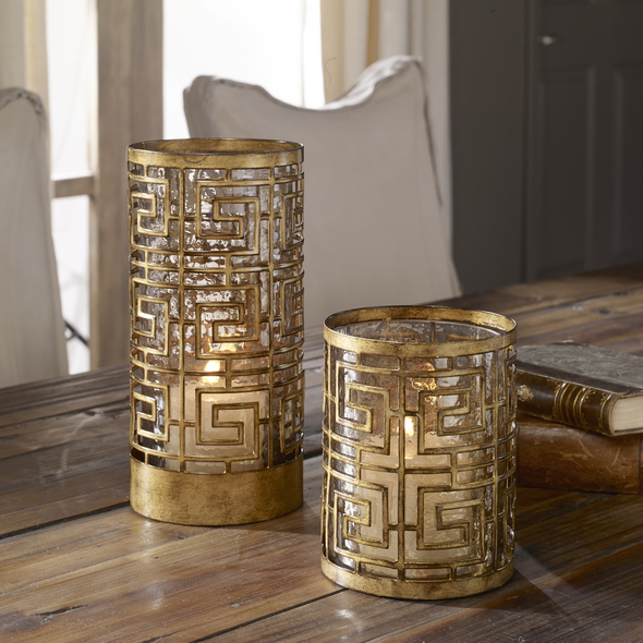 decorative glass tea light holders Uttermost Candleholders This Set Of Two Hurricane Candleholders Features A Heavily Antiqued Gold Finish Over An Open Iron Pattern Surrounding Copper Bronze Luster Glass Globe Inserts. Includes One 3"x 3" And One 3"x 4" White Candles.