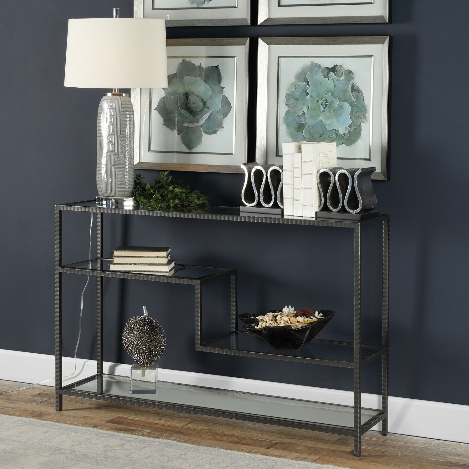 modern table design Uttermost  Console & Sofa Tables Industrial Inspired Function With Multi-level Display Shelves, Featuring Ribbed Iron Finished In An Aged Gunmetal With A Light Rust Patina. Shelves Are Clear Tempered Glass.